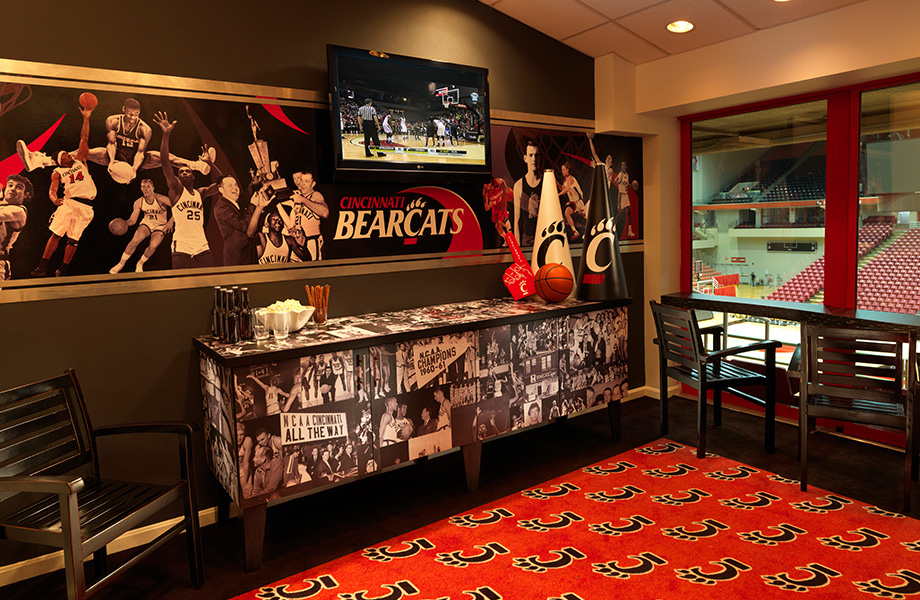 A hospitality suite decorated with team logos and graphics