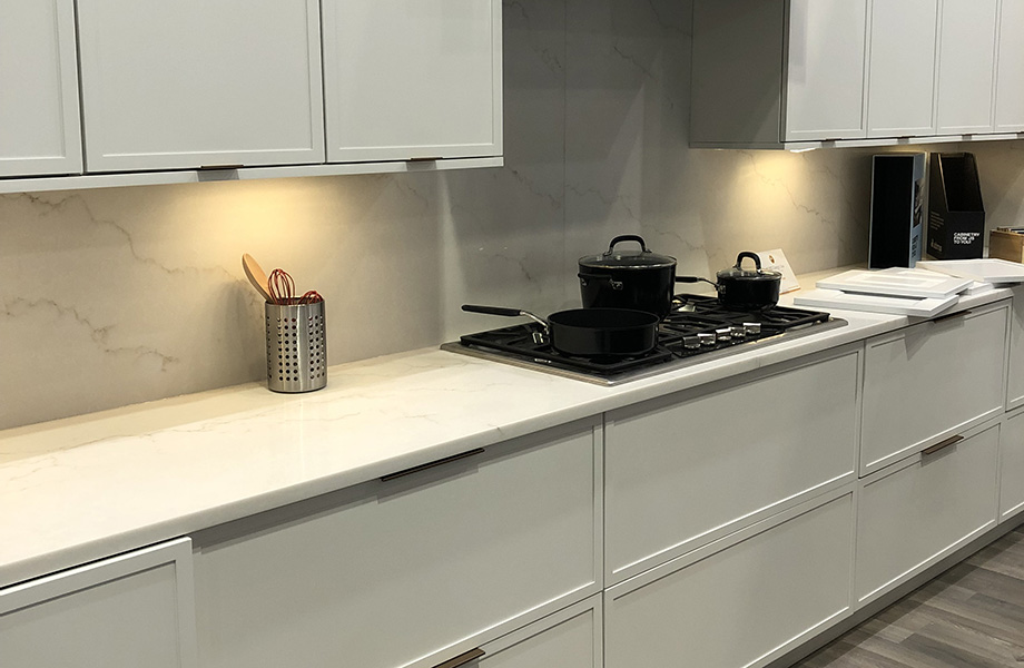 Adornus Soft White cabinets in modern kitchen with stove and pots