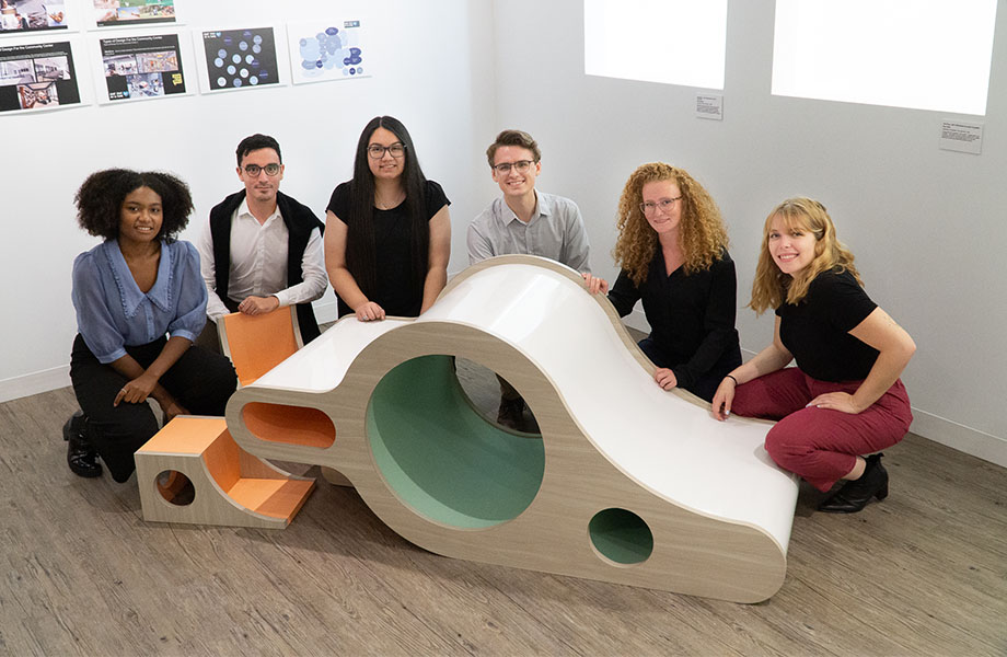 Past Formica Group FORM Competition winners pose with a winning furniture design