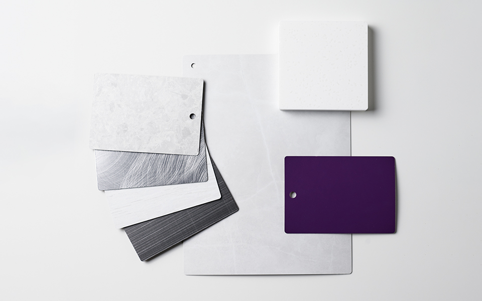 Collection of Formica laminate samples in gray and white with a purple pop