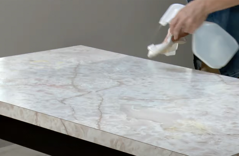 A person cleaning a countertop