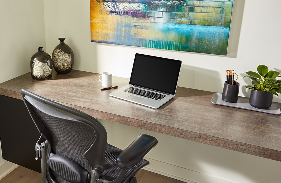 Home office with Formica laminate desktop, laptop and chair