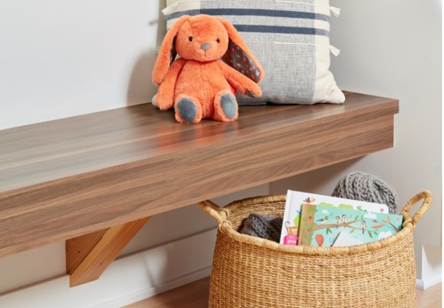 Bench in Walnut Butcherblock Formica Laminate with stuffed animal, pillow and basket of books