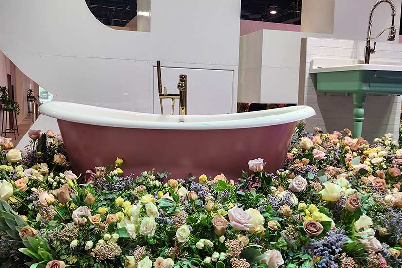 Pink bathtub surrounded by flowers