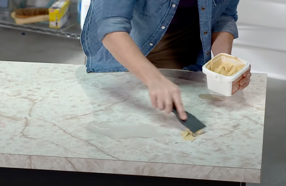 A person cleaning a countertop