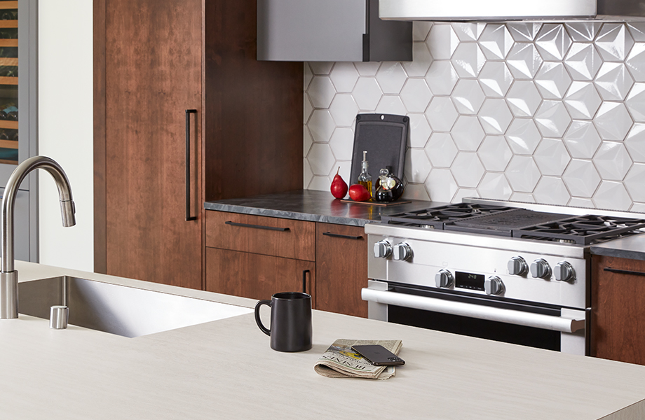 Kitchen with range and Formica laminate island and countertops