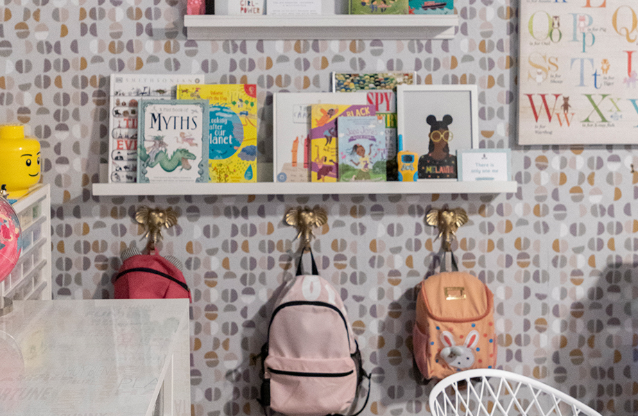 Flex room featuring a writable desk, craft supplies, wallpaper, and bookshelves.