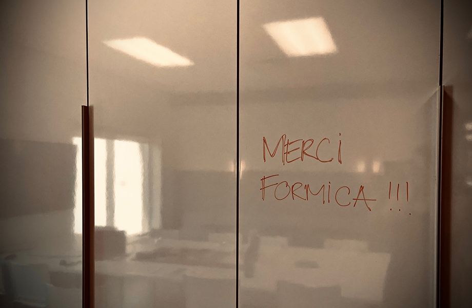 A markerboard cabinet with the words "thanks Formica" written in French