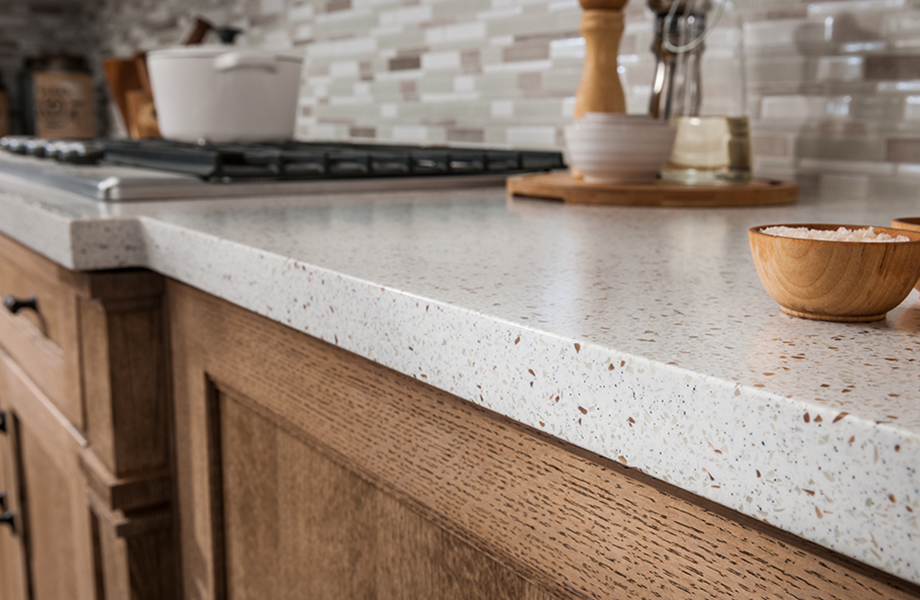 742 Blanco Terrazzo acrylic solid surface countertop in kitchen with wood cabinetry