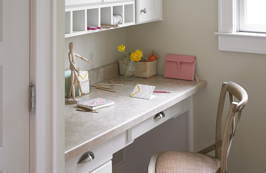Desk tucked in nook with 3526 Travertine surface with chair and note cards