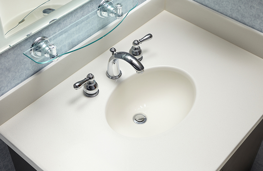 Bathroom sink and countertop in 757 Luna Sand acrylic solid surface with faucet and shelf