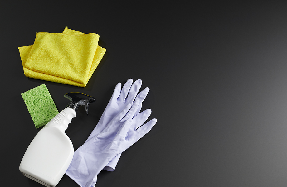 Gloves, sponge and cleaner on Formica Infiniti Counter