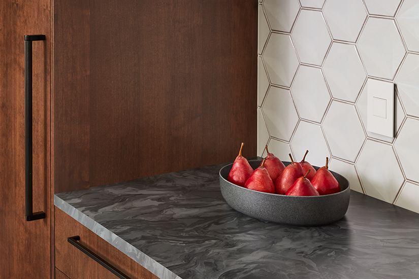 Wooden kitchen cabinets and Marbled Gray Formica laminate countertops with pears