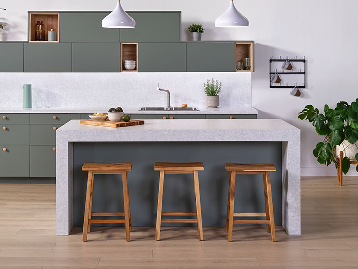 Formica laminate kitchen waterfall countertop with barstools and plant