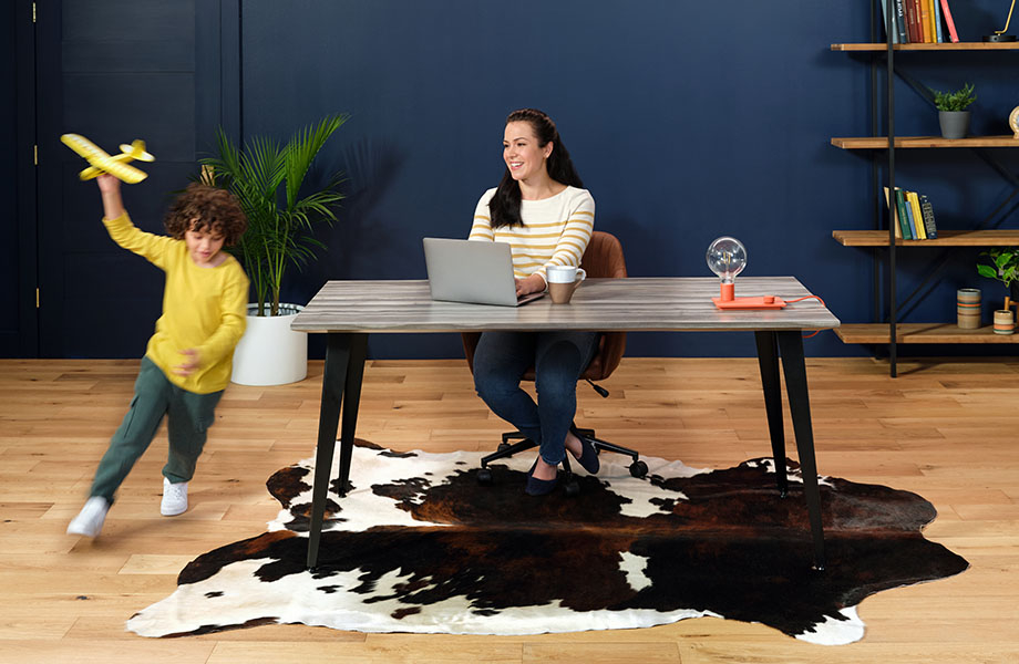 Woman and child in home office with Formica laminate desk and cowhide rug 