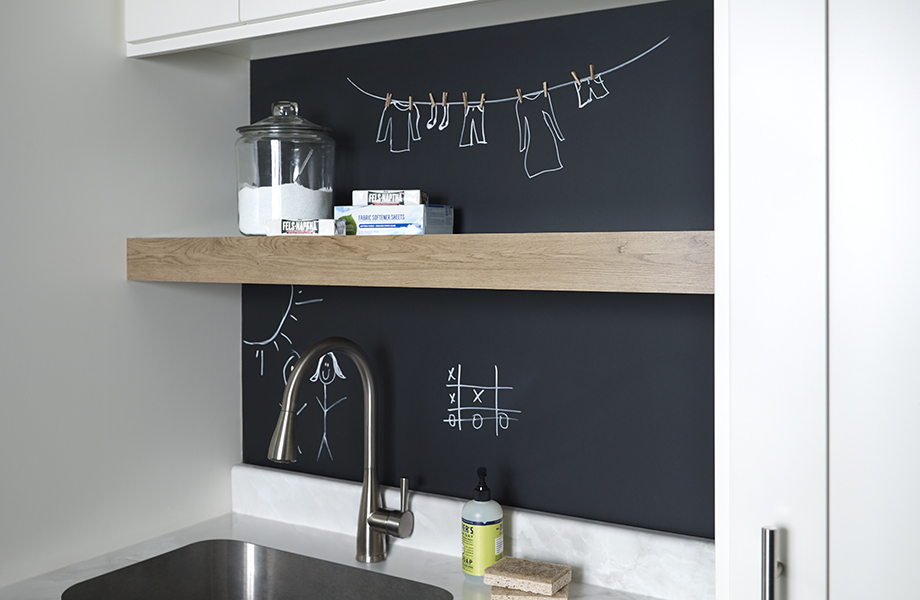 Black chalkboard laminate with open shelving above sink