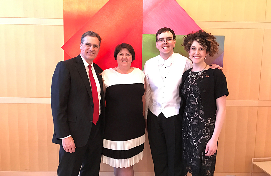 A family of four posing at an event