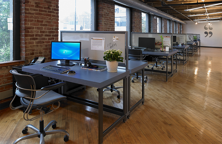 Office workstations with 8814 Denim Twill desktops and M7927 Gray Magnetic Markerboard partitions