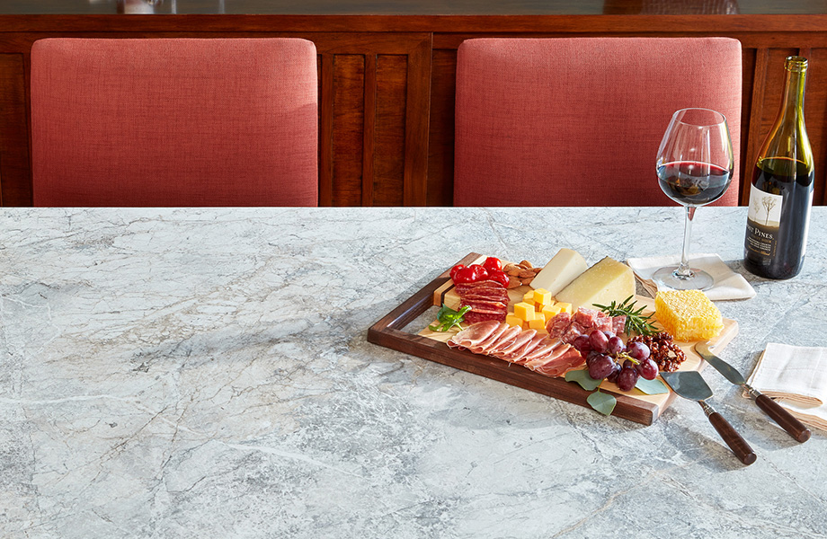 Mediterranean Marble 180fx® Laminate tabletop with chairs, wine and food