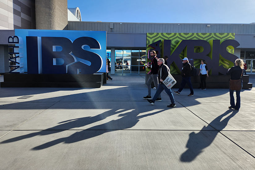 People walking in front of large KBIS 2023 sign