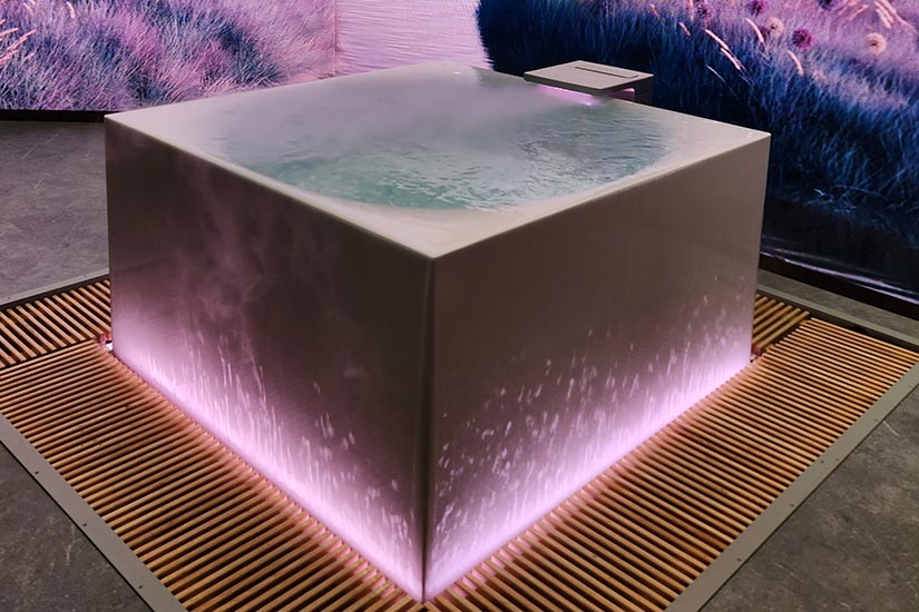 Square soaking tub with pink lighting