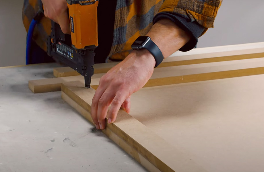 Person staples strips of wood together