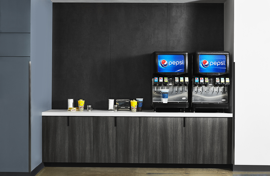 Self-service soda fountain with M9422 Black Patina metallic wall, 5792 Inked Oak cabinets and 416 Luna Pewter white acrylic countertops