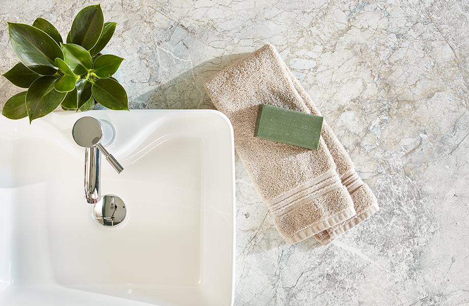 White marble Formica laminate countertop with sink, towel and soap