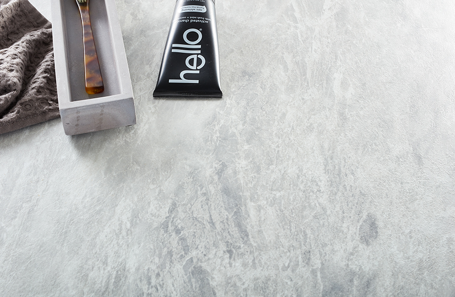 Close-up of white marbled Formica laminate counter with shaving supplies