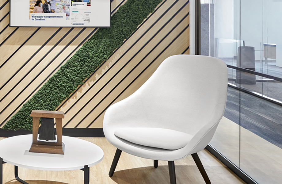 A white chair in an office with slatted walls