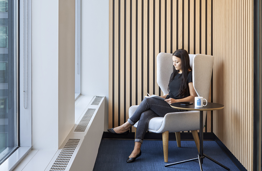 A person sitting in a chair looking out a window