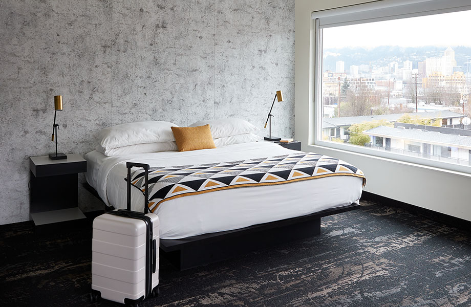 Pared característica de laminado 8684 58 Birchbark Formica® en una moderna habitación de hotel con cama y gran ventana