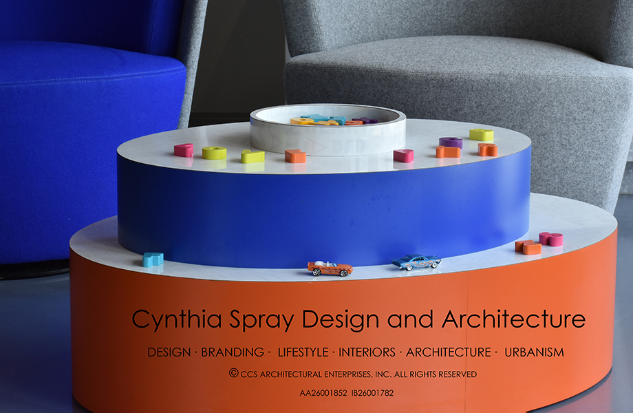 Close-up of Cynthia Spray designed circular table in Clementine and Spectrum Blue Formica laminate